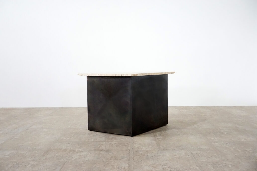 割れてしまったトラバーチンの天板。割れるという物語を継承しセンターテーブルに。土台部分はスチールの黒染め塗装仕上げ。2:10斜め