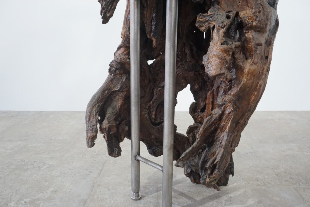 インテリアアクセントとして使われてきた流木をステンレス天板を交えてサイドテーブルへカスタム。流木の流動的で自然な風合いと、ステンレスのインダストリアルモダン感のコントラストが際立つものに仕上がりました。天板はステンレス板をランダムに荒らしたサンディング仕上げ。足下左後ろ