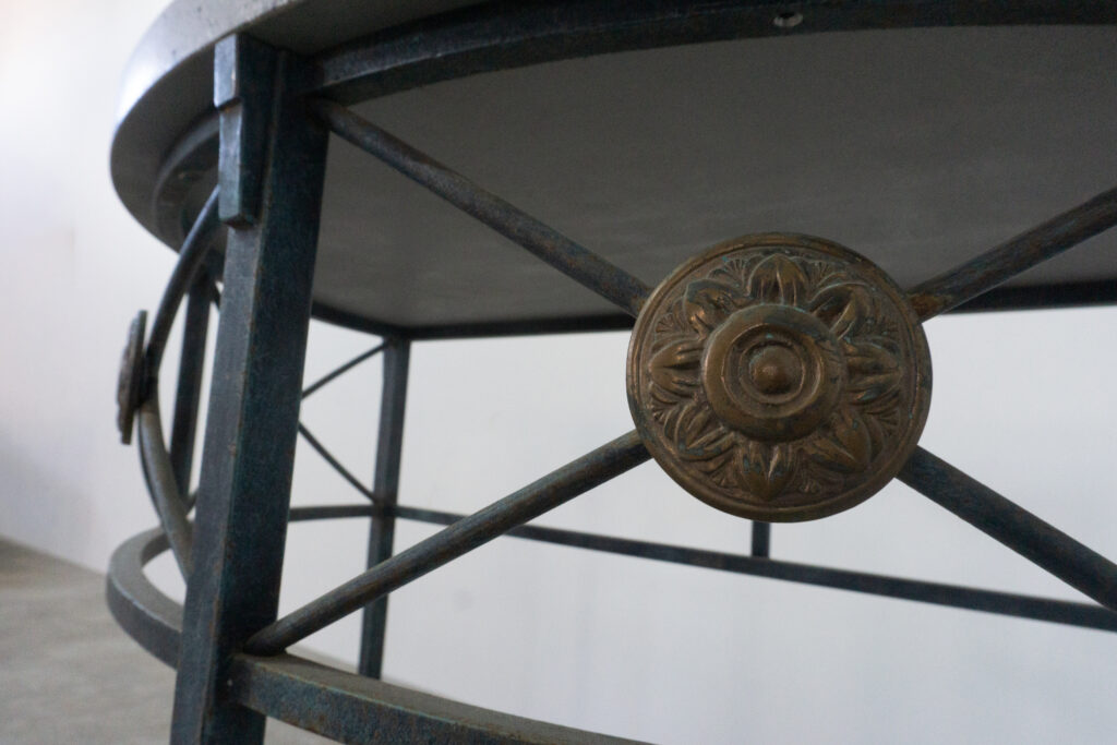 1890年代フランス製の鍛鉄コンソール。オリジナルはガラス天板ですが、紛失のため、天然石をモールテックスで包んで仕上げたビールストーン天板にカスタム。緑青がかった鍛鉄は足元がテーパー、ボールになっており丹念に制作されています。また、アール・ヌーヴォーの影響も垣間見れる花模様のブロンズパーツも魅力的です。メイン装飾