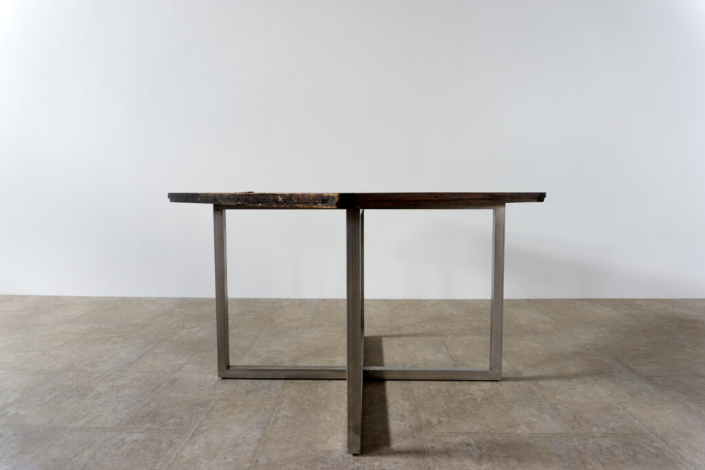 古い木製扉を再利用したテーブル。既存の木枠はそのまま活かし、中央にはステンレス板をフラットに納めています。天板は段差を抑えた構成で、実用性と意匠性を両立。脚部にはステンレス角パイプを使用し、十分な強度と安定性を確保。木部の経年変化とステンレスの均質な質感が対比され、空間に適度な緊張感を与える。一点ごとに表情の異なる木枠を使用しているため、同一仕様でも個体差があります。住宅空間から店舗什器まで幅広く使用可能。Threshold / Plane 01横