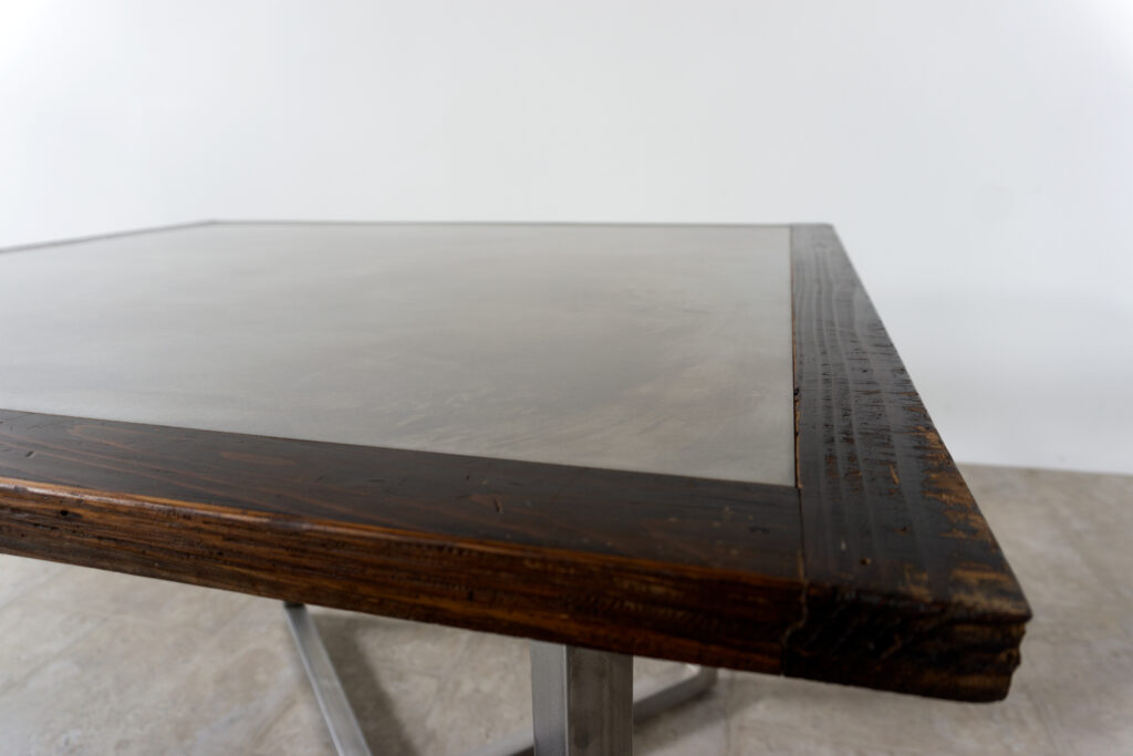 古い木製扉を再利用したテーブル。既存の木枠はそのまま活かし、中央にはステンレス板をフラットに納めています。天板は段差を抑えた構成で、実用性と意匠性を両立。脚部にはステンレス角パイプを使用し、十分な強度と安定性を確保。木部の経年変化とステンレスの均質な質感が対比され、空間に適度な緊張感を与える。一点ごとに表情の異なる木枠を使用しているため、同一仕様でも個体差があります。住宅空間から店舗什器まで幅広く使用可能。Threshold / Plane 01天板斜め