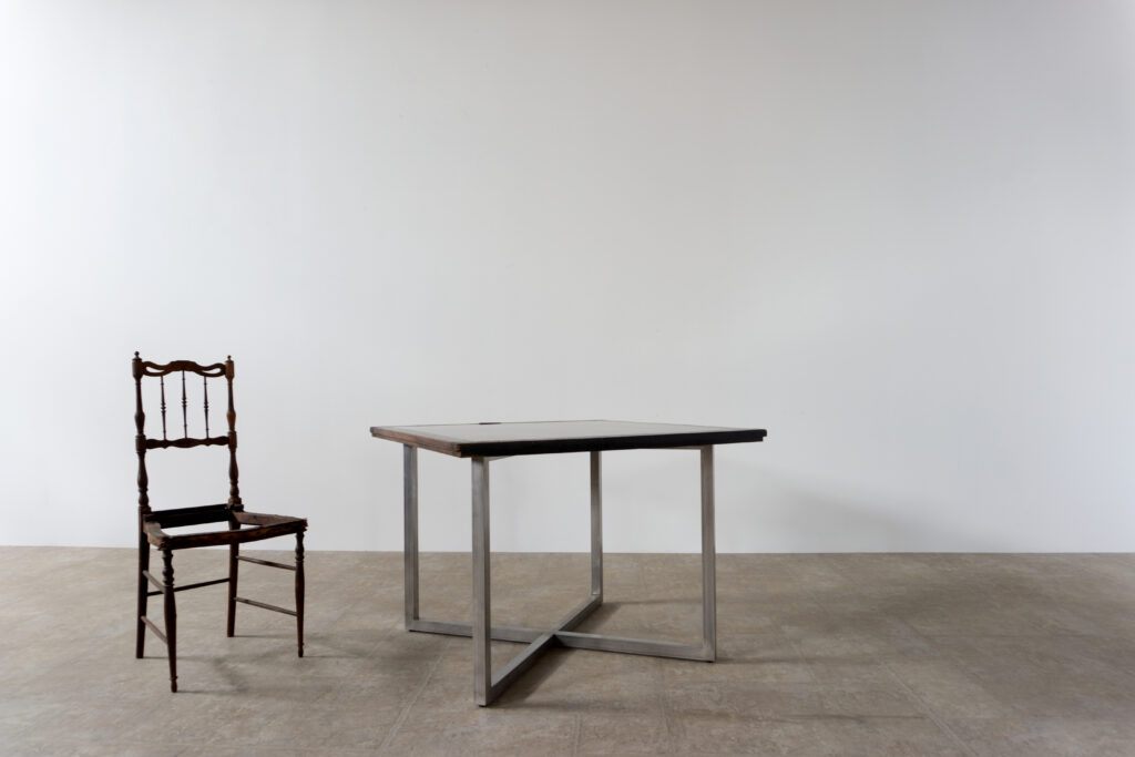 古い木製扉を再利用したテーブル。既存の木枠はそのまま活かし、中央にはステンレス板をフラットに納めています。天板は段差を抑えた構成で、実用性と意匠性を両立。脚部にはステンレス角パイプを使用し、十分な強度と安定性を確保。木部の経年変化とステンレスの均質な質感が対比され、空間に適度な緊張感を与える。一点ごとに表情の異なる木枠を使用しているため、同一仕様でも個体差があります。住宅空間から店舗什器まで幅広く使用可能。Threshold / Plane 01椅子一脚